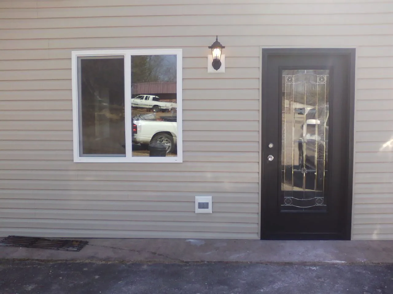 New siding, window and entry door on the side of an addition in New Berlin